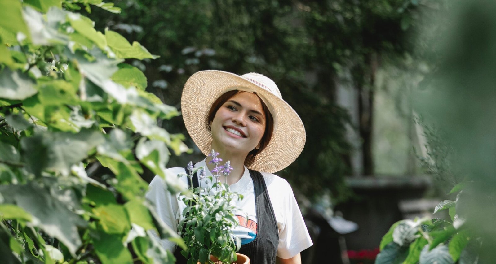 Promoting an eco-friendly lifestyle: An ethnic woman carrying a flowerpot, ready to nurture nature. Reflecting sustainable living in 2023 guide.