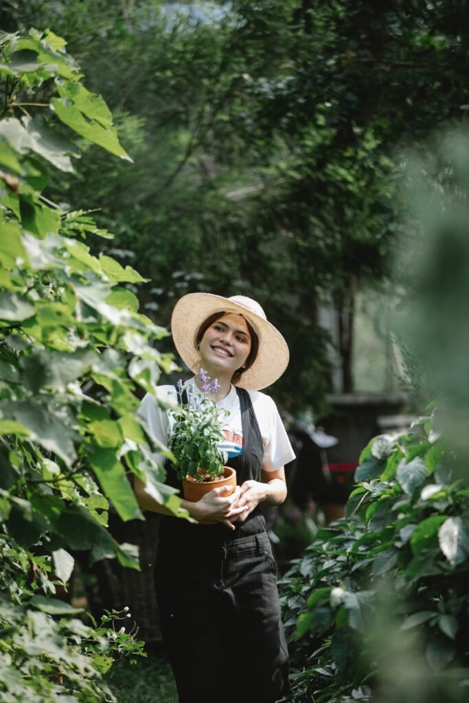 Promoting an eco-friendly lifestyle: An ethnic woman carrying a flowerpot, ready to nurture nature. Reflecting sustainable living in 2023 guide.