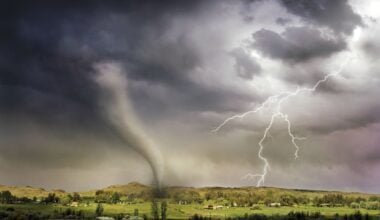 Global Warming Unleashed: Devastating scene of lightning and tornado striking a village, underlining the heightened climate risks we face.